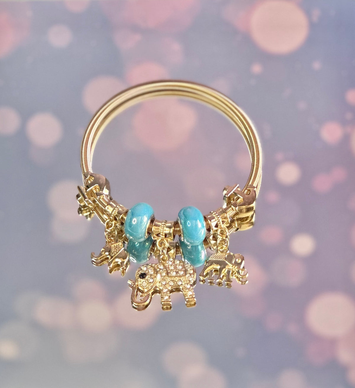 B-Gold plated elastic bracelet with sky blue beads and charms