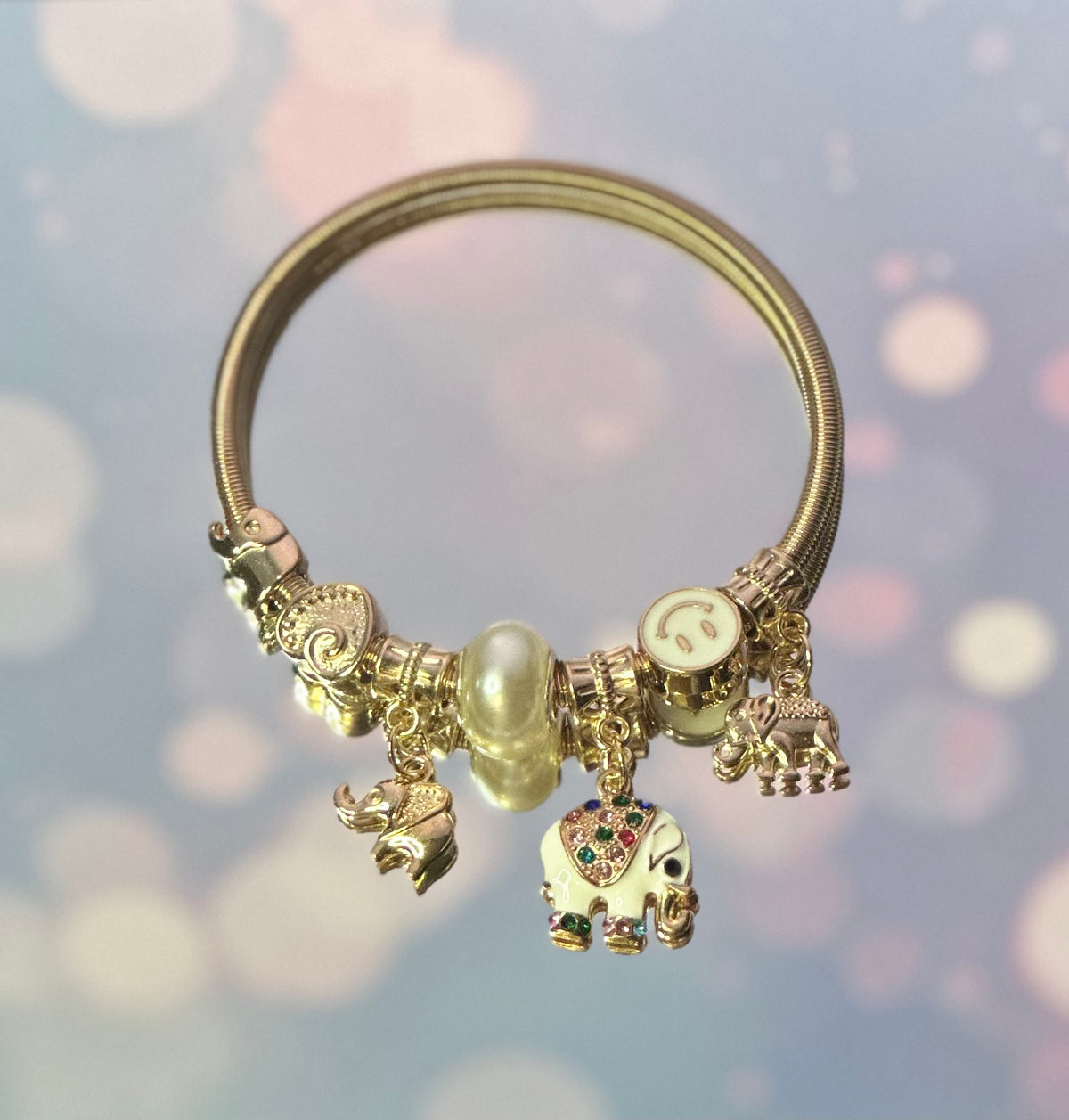 A-Gold plated elastic White Elephant bracelet with charms