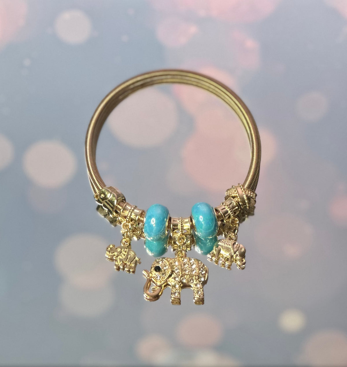 A-Gold plated elastic bracelet with sky blue beads and charms